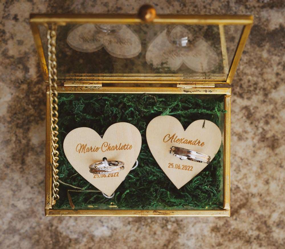 coffret transparent contenant les anneaux des mariés avec leurs prénoms et date du mariage